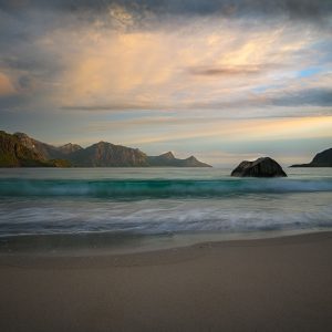 Sanfte Wellen am Hauklandstrand auf den Lofoten vor Bergen bei Abendlicht